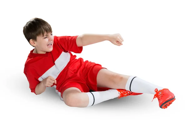 Menino jogador de futebol em uniforme vermelho — Fotografia de Stock