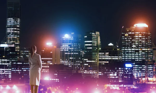 Woman looking at night city — Stock Photo, Image