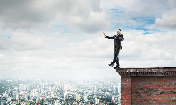 Businessman with blindfolder on eyes