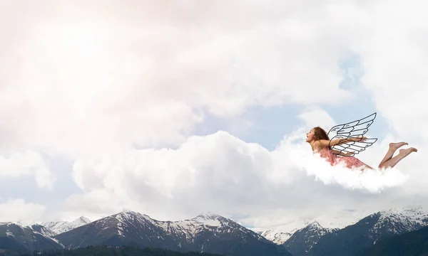 Woman flying high in blue sky — Stock Photo, Image