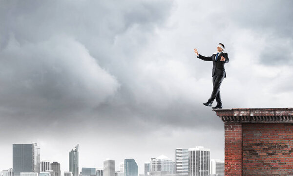 Businessman with blindfolder on eyes 