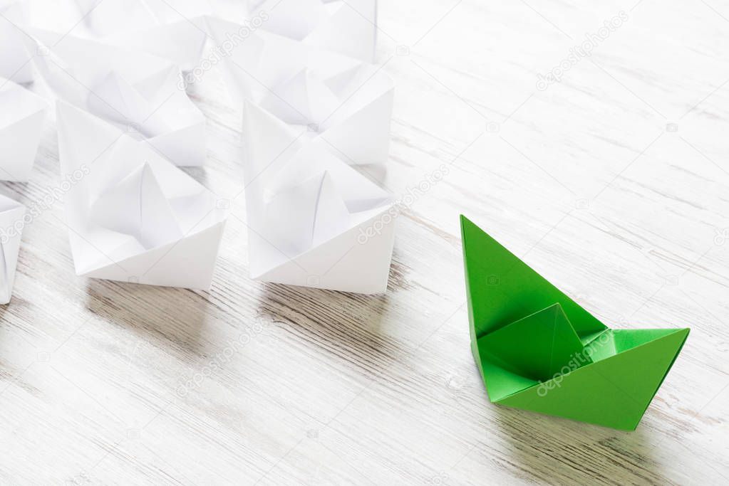 Set of origami boats on wooden table 