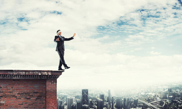 Businessman with blindfolder on eyes