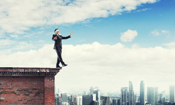 Businessman with blindfolder on eyes