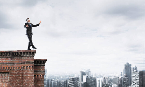 Businessman with blindfolder on eyes 