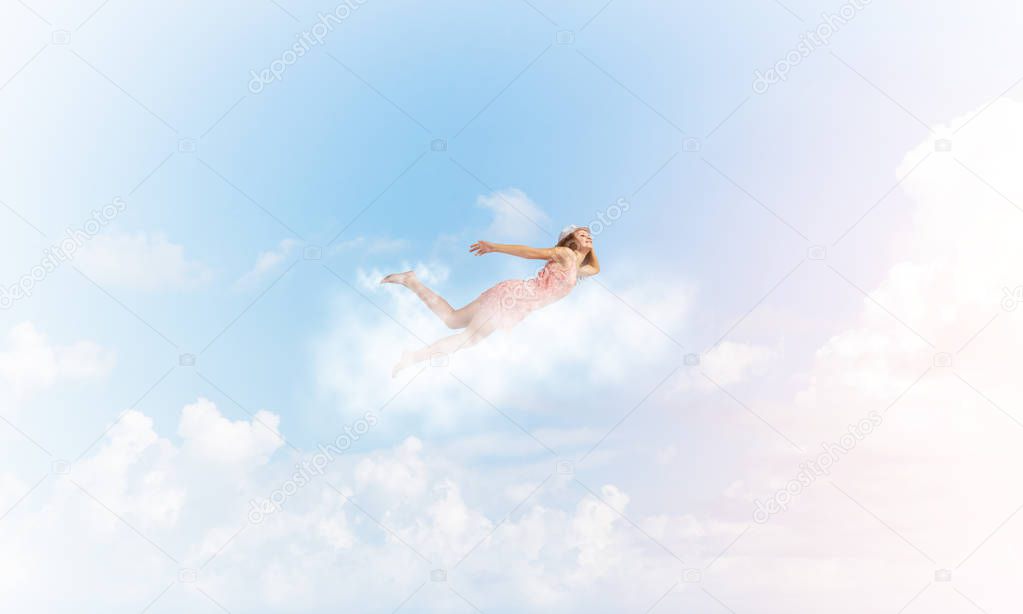 woman flying high in blue sky