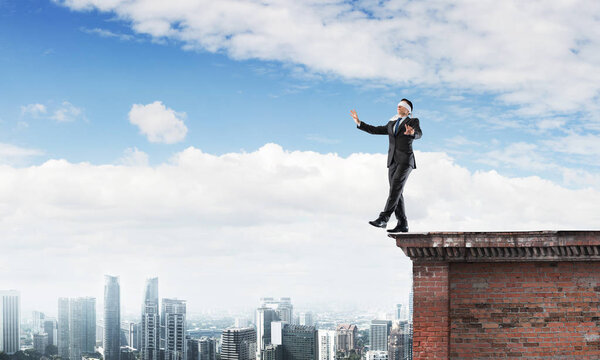 Businessman with blindfolder on eyes