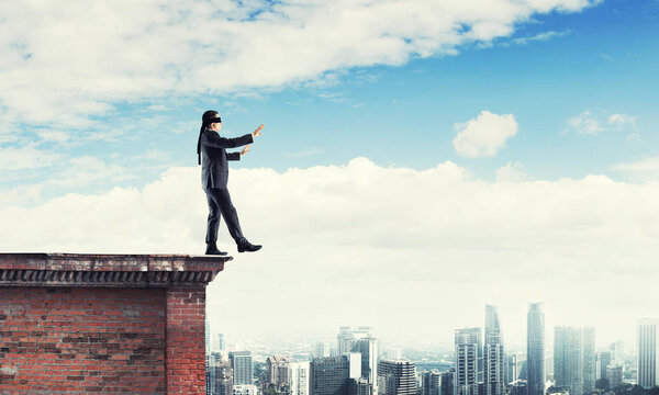 Businessman with blindfolder on eyes