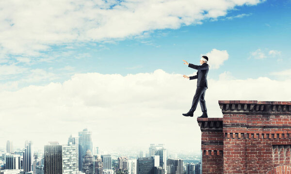 Businessman with blindfolder on eyes