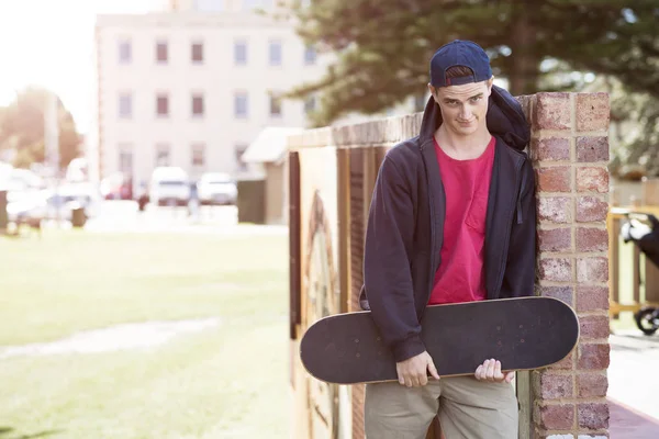 Schöner Kerl mit Skateboard — Stockfoto