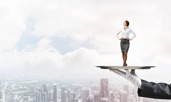 Businesswoman standing on tray — Stock Photo, Image