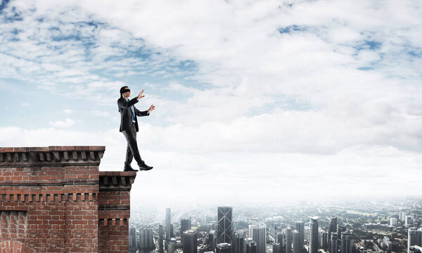 Businessman with blindfolder on eyes 