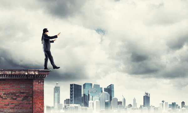 Businessman with blindfolder on eyes 