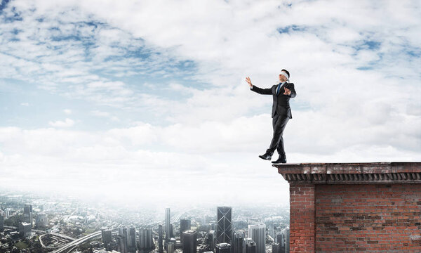 Businessman with blindfolder on eyes