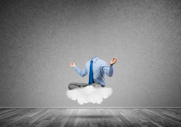 Headless businessman sitting on cloud — Stock Photo, Image