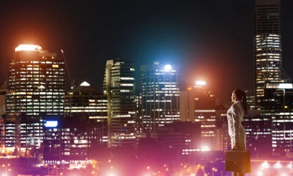 Woman looking at night city — Stock Photo, Image