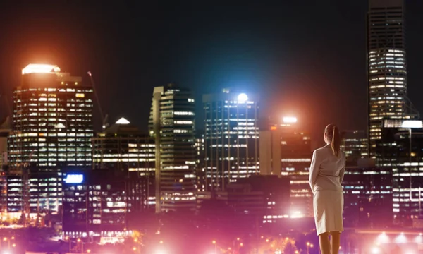 Woman looking at night city — Stock Photo, Image