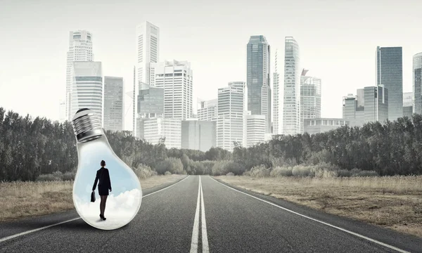 Businesswoman trapped inside of light bulb — Stock Photo, Image