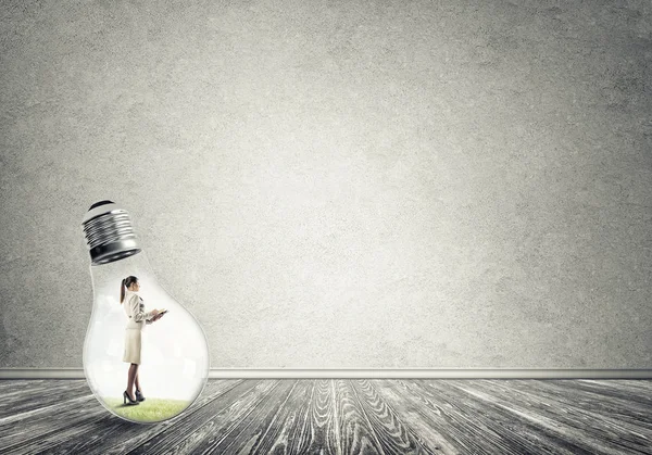 Businesswoman inside of light bulb — Stock Photo, Image