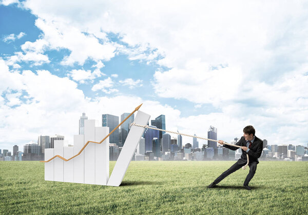 Businessman pulling graph with rope  