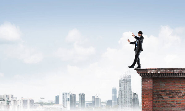 Businessman with blindfolder on eyes