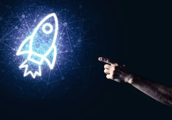 Rocket glowing icon and businessman hand — Stock Photo, Image