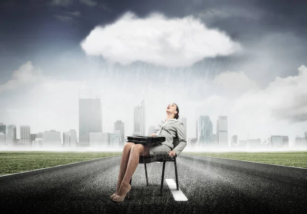 Femme d'affaires assise sous la pluie — Photo