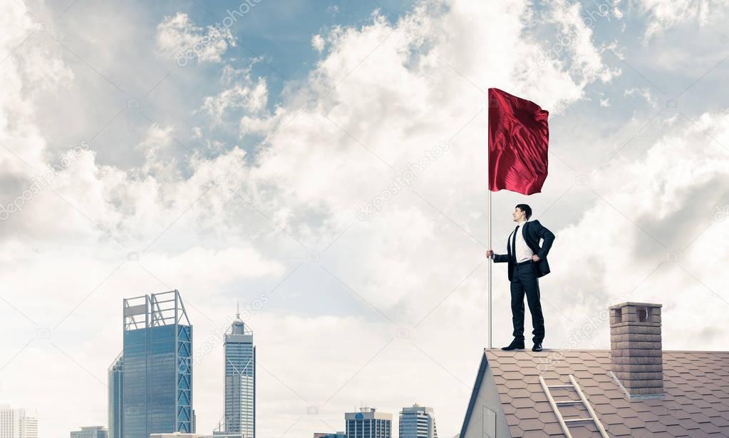 Young businessman with flag 