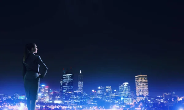 Woman looking at night city — Stock Photo, Image