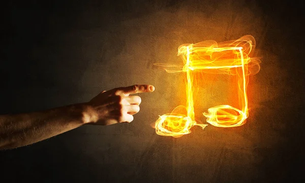 Close up of person hand and fire music symbol — Stock Photo, Image