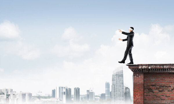 Businessman with blindfolder on eyes