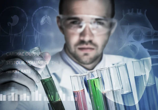 Young scientist mixing reagents — Stock Photo, Image