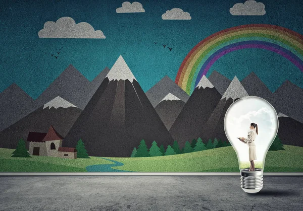 Businesswoman inside light bulb — Stock Photo, Image