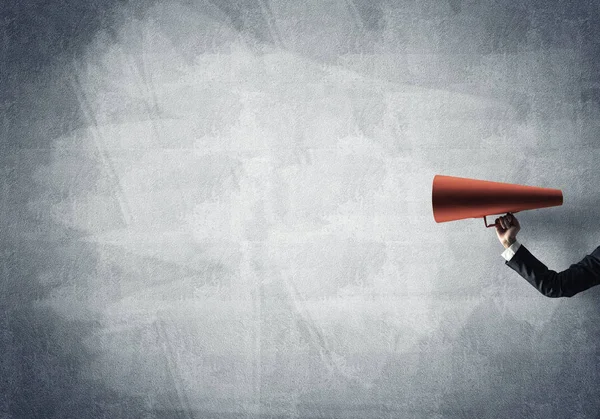 Businesswoman making announcement in paper trumpet — Stock Photo, Image