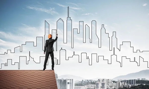 Male engineer standing on house roof — Stock Photo, Image