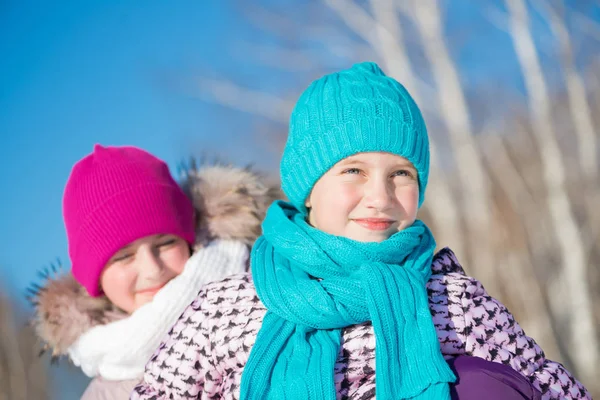 Cute girls riding sled at wintertime — Stock Photo, Image