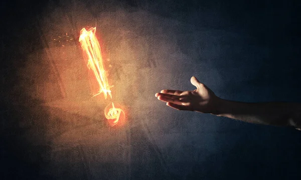 Hand with fire glowing exclamation mark — Stock Photo, Image