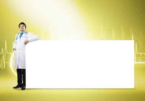 Doctor with white blank banner — Stock Photo, Image