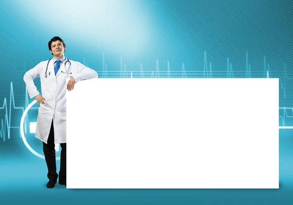 Doctor with white blank banner — Stock Photo, Image