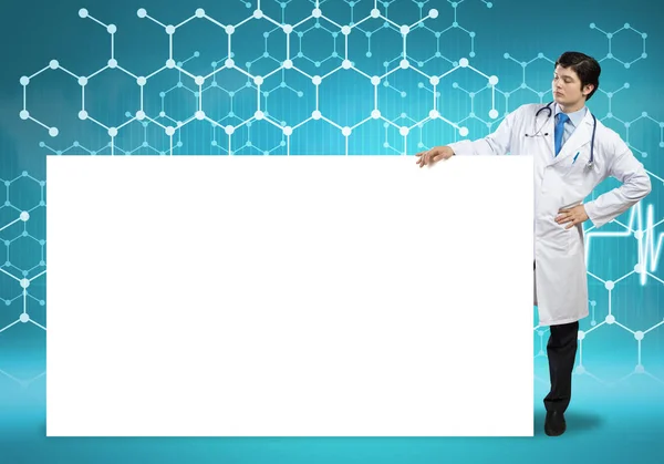 Doctor with white blank banner — Stock Photo, Image