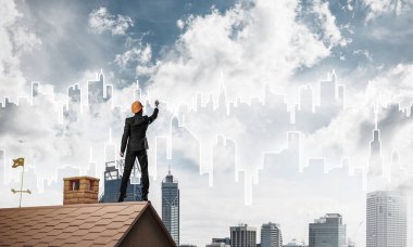 Mühendis adam evin çatısında ayakta