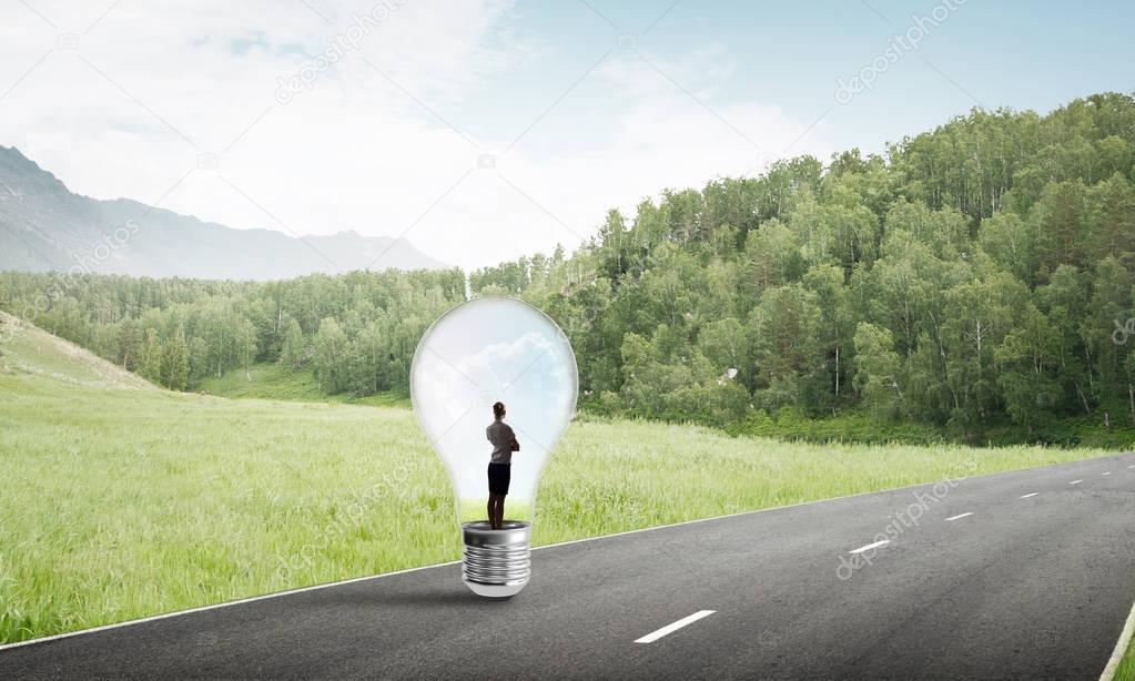 businesswoman trapped inside of light bulb