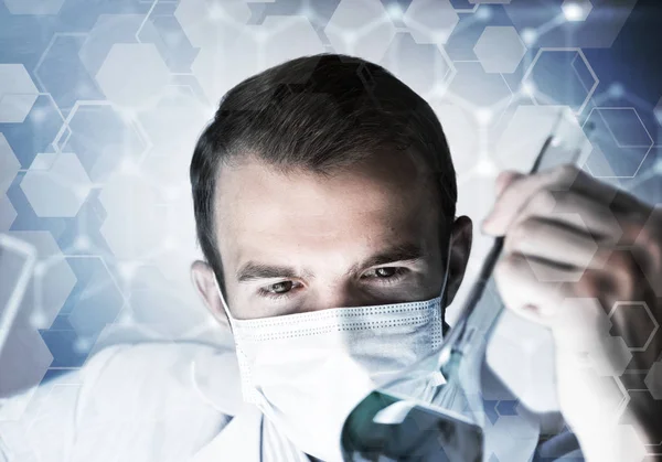 Young scientist mixing reagents — Stock Photo, Image