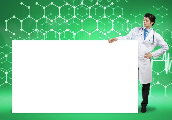 Doctor with white blank banner — Stock Photo, Image