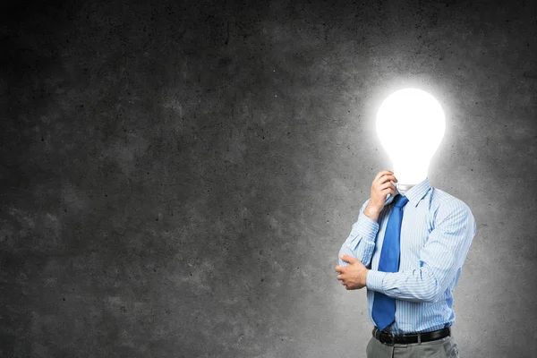 Businessman with lamp head — Stock Photo, Image