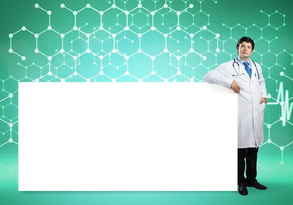 Doctor with white blank banner — Stock Photo, Image