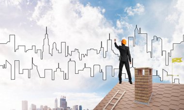 Erkek mimar mavi gökyüzüne modern şehrin siluetini çizer. Karışık ortam