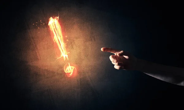 Hand with fire glowing exclamation mark — Stock Photo, Image