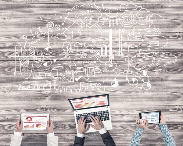 Group of three people with devices in hands