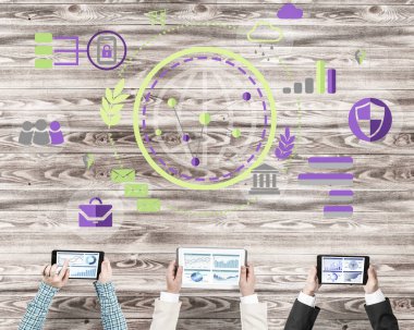 Bir grup ellerinde aygıtlarla üç insan